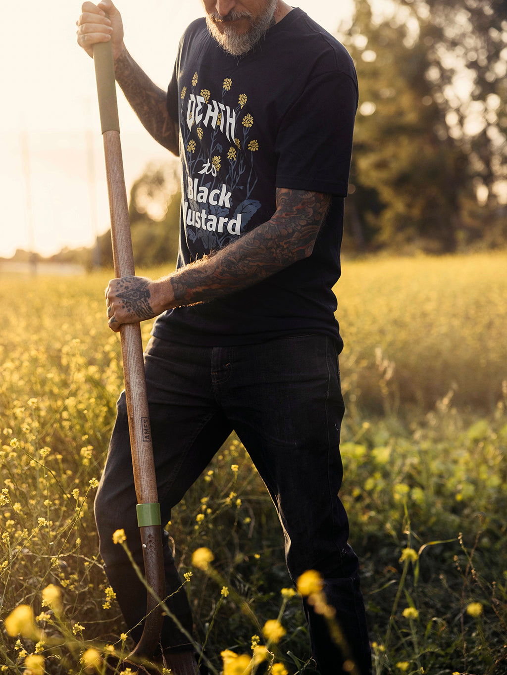 Man with shovel doing conservation work wearing death to black mustard shirt