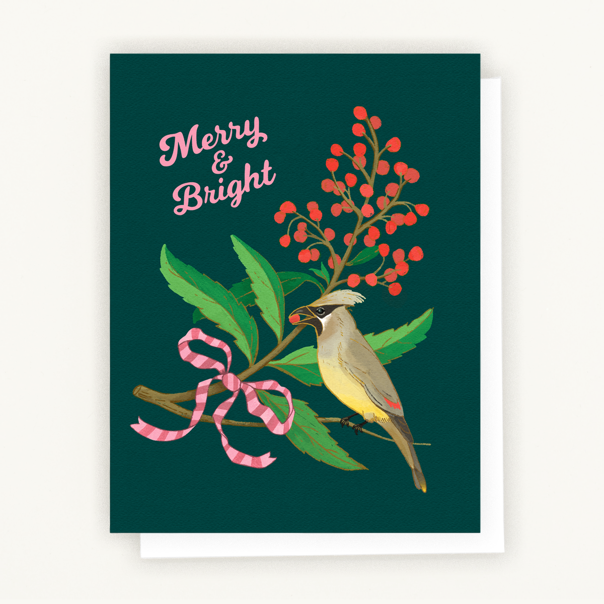 A holiday greeting card with the phrase “Merry & Bright,” featuring an illustrated cedar waxwing bird perched on a toyon branch with red berries and green leaves, tied with a pink ribbon.