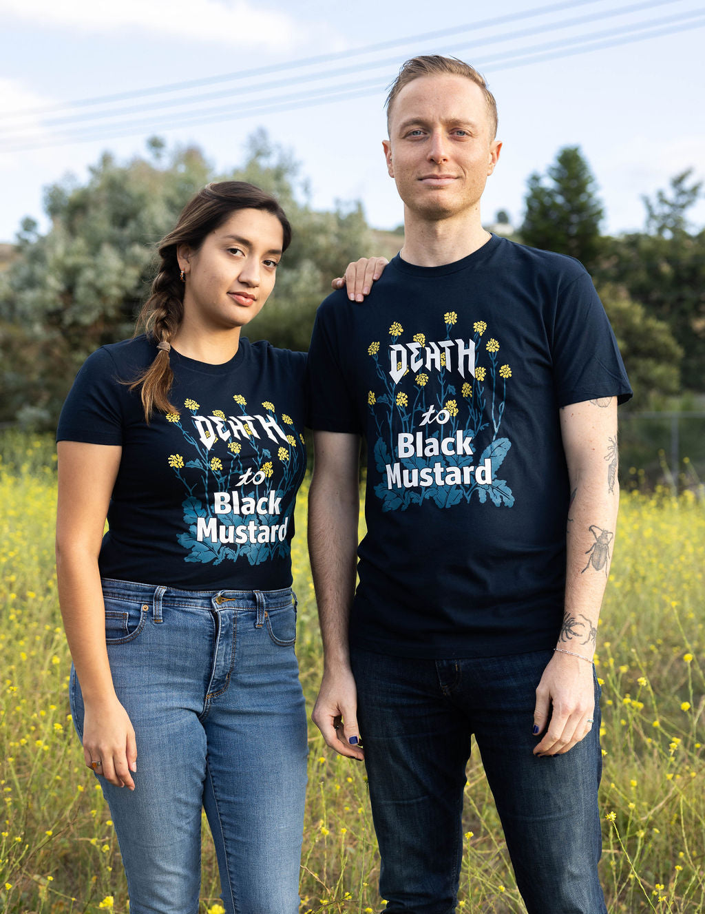 Two people wearing Death to Black Mustard shirts, united in conservation awareness.