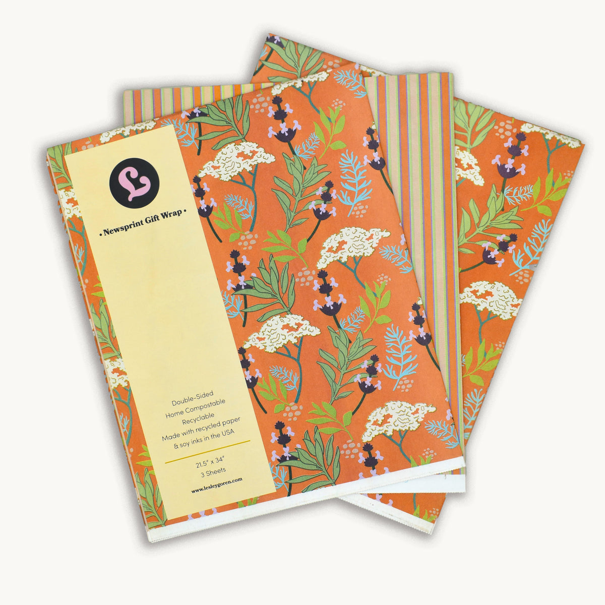 Reversible gift wrap featuring yarrow, sage, and native wildflowers and stripes on a warm, earthy background.