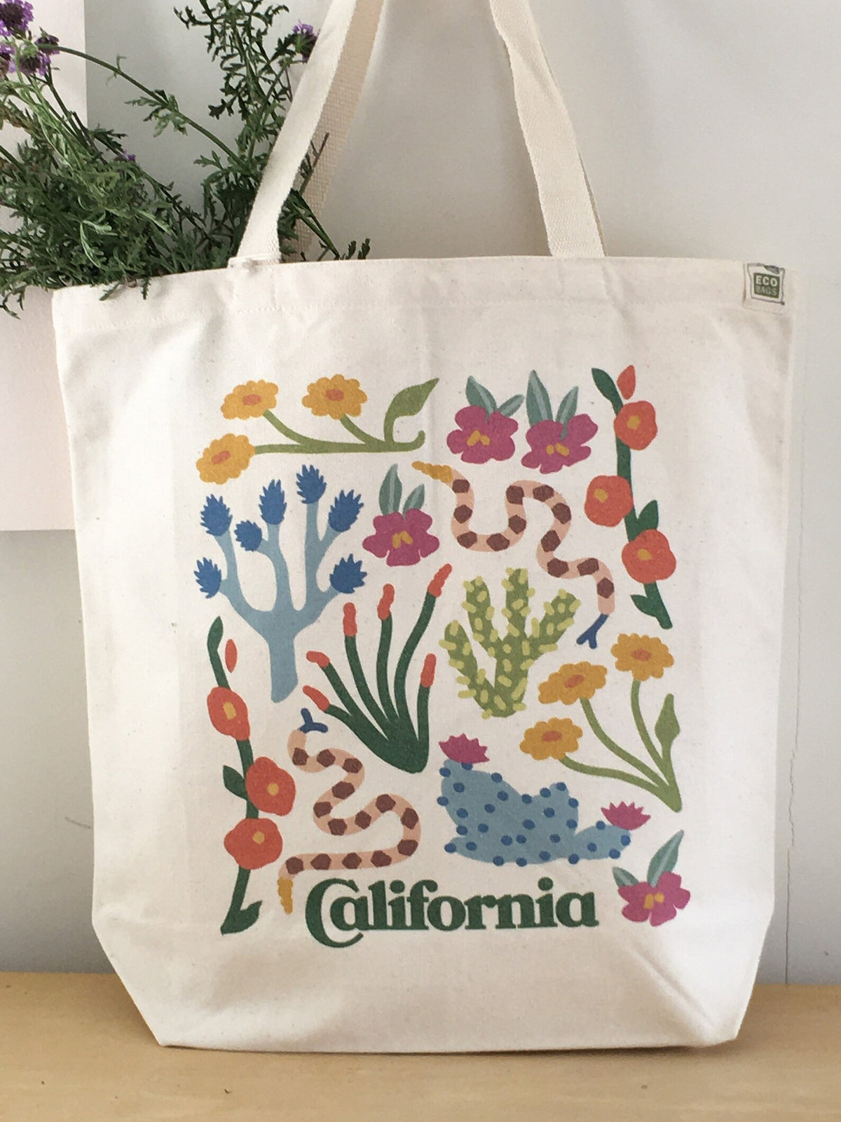 Desert Flora Tote being used for carrying groceries, showcasing its stylish and eco-friendly design.